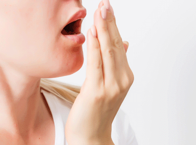 画像：自分の口臭を確認する人
